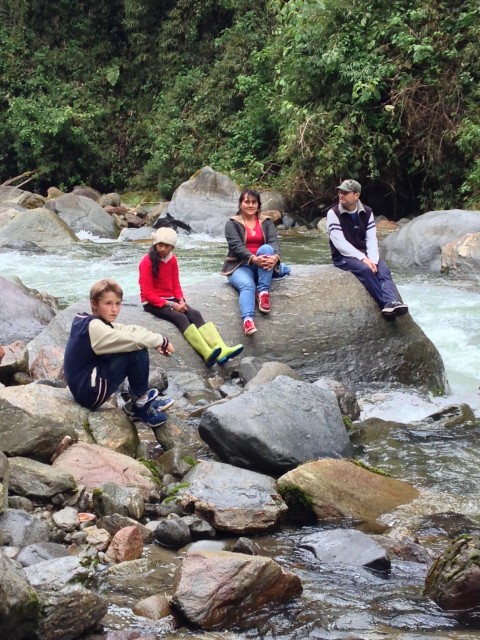 Tourists sitting on the river rocks